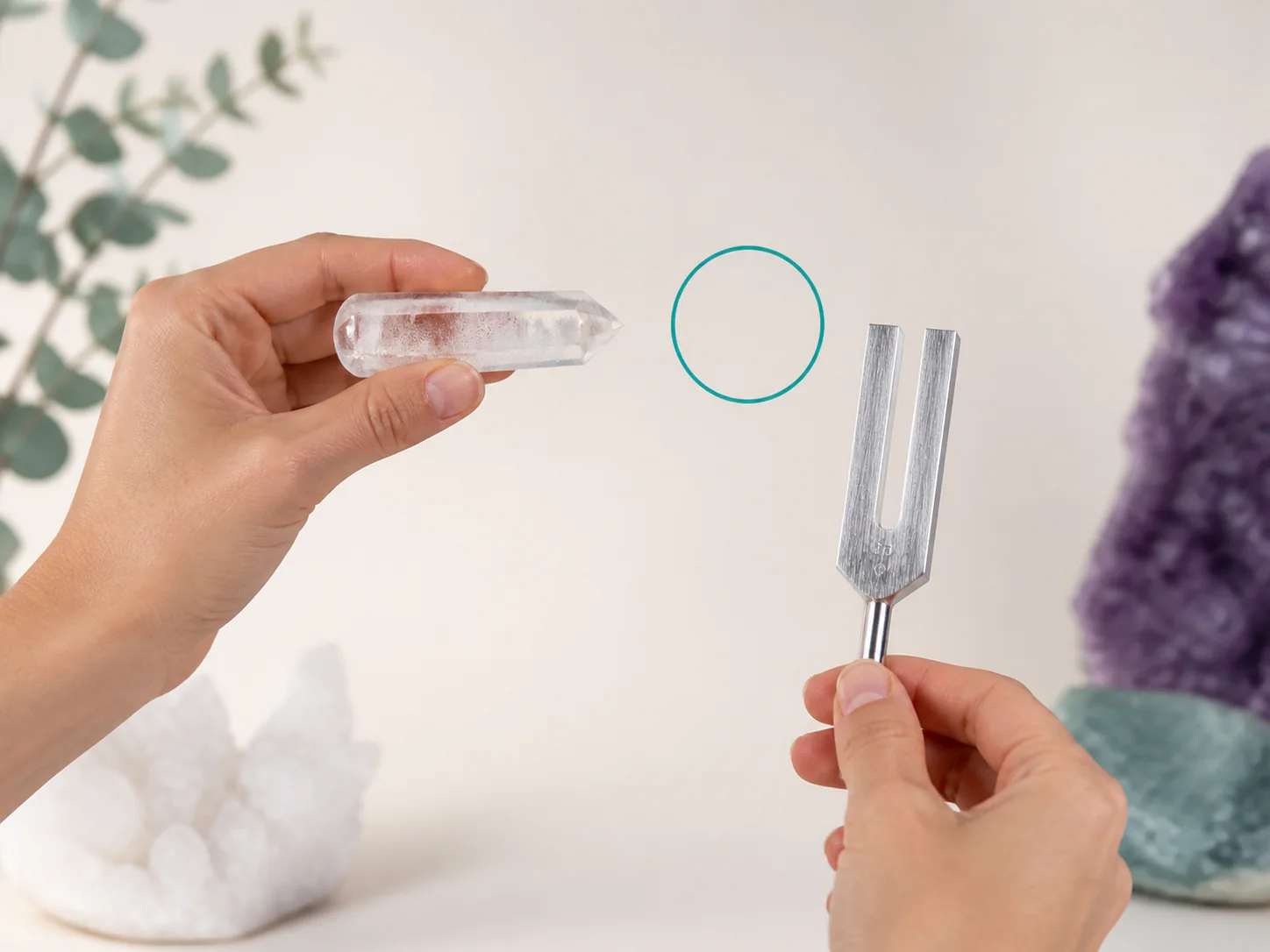 A clear quartz wand pointed toward a neutral focus marker while remaining safely separated from it.
